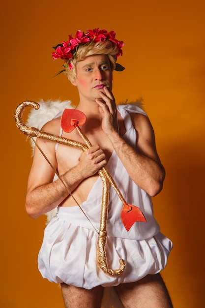 Valentine's day concept. Portrait of the God of love - Cupid with bow and arrow.