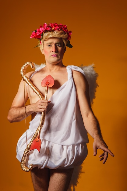 Valentine's day concept. Portrait of the God of love - Cupid with bow and arrow.