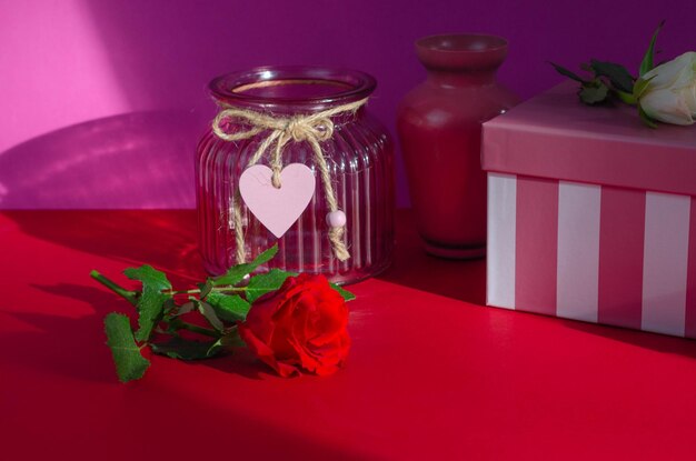 Valentine's day concept. red rose and gift box on red background