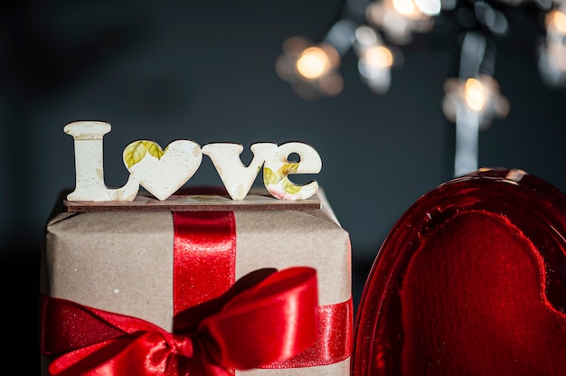 Valentine's Day. Decoration with the word Love and gift box and red hearts