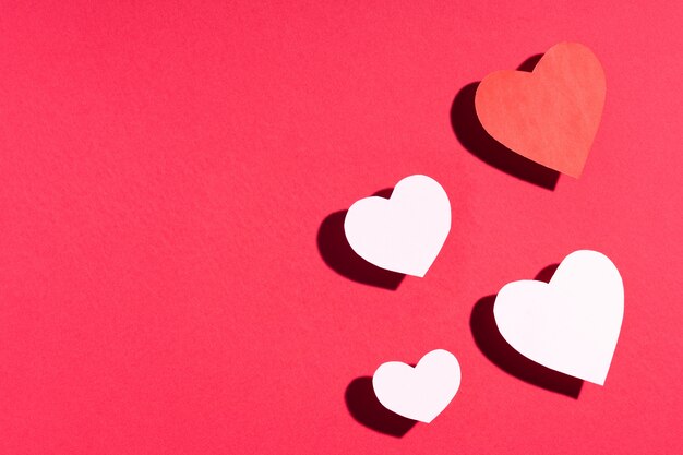 Photo valentine's day frame composition. red white paper hearts on red . top view, flat lay, copyspace