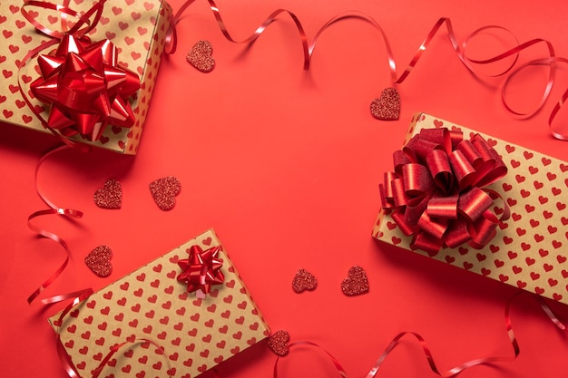 Photo valentine's day gift box and hearts on red background