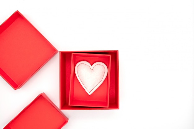 Photo valentine's day, gift box of kraft paper with a red ribbon and candles. rustic style