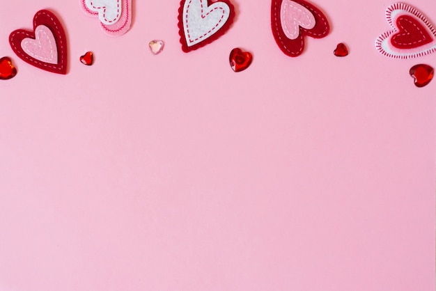 Valentine's day greeting card concept. Border of hearts on a pink