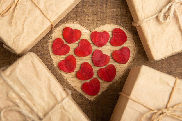 Valentine's Day greetings concept Heart shape carved on the wood with Gift boxes