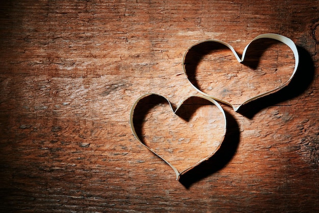 Valentine's Day heart made of ribbon on wooden background