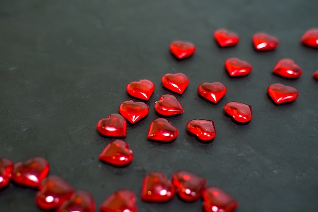 Valentine's day hearts scattered on a dark