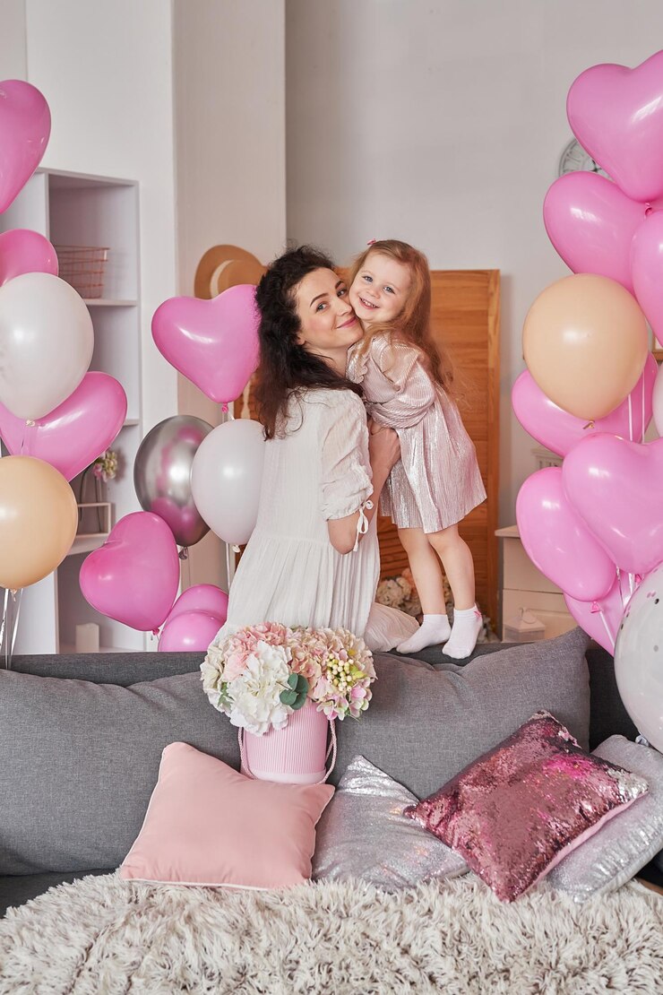 Valentine's Day International Day of Happiness Studio apartment in loft style Holiday decor Mothers Day Woman mother and baby girl with balloons and flowers Celebration