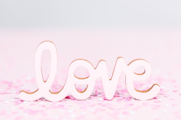 Valentine's Day LOVE sign on a pink background.