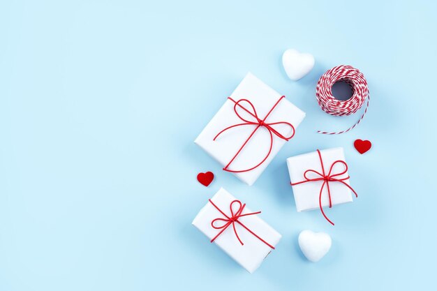 Valentine's Day Mother's day art design concept Red white wrapped gift box isolated on pastel light blue color background flat lay top view