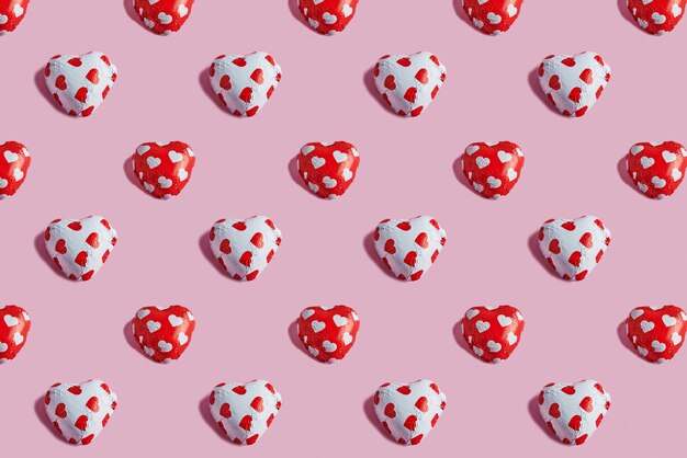 Valentine's Day pattern with candy hearts on pink