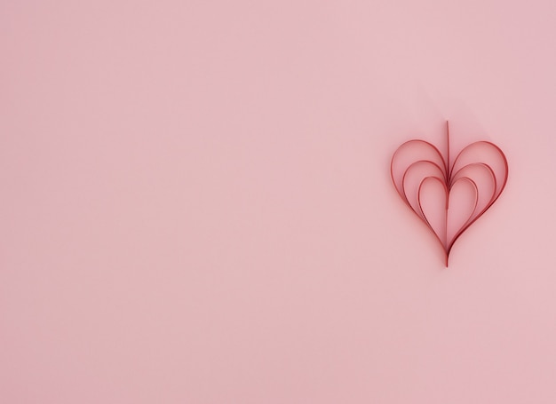 Fondo rosa di san valentino con cuore di carta rosso quilling fatto a mano. biglietto di auguri di san valentino. stile piatto laici con spazio di copia. amore, felicità e concetto di matrimonio.