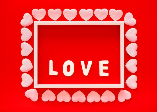 Valentine's day red background with white frame, word love and pink hearts. mother's day, march 8 greeting card