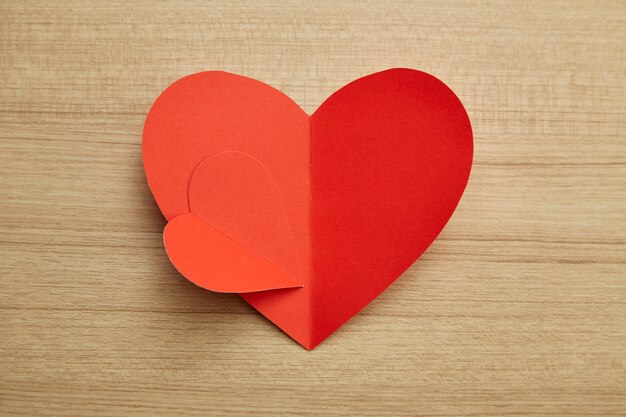 Valentine's day red paper heart on wooden