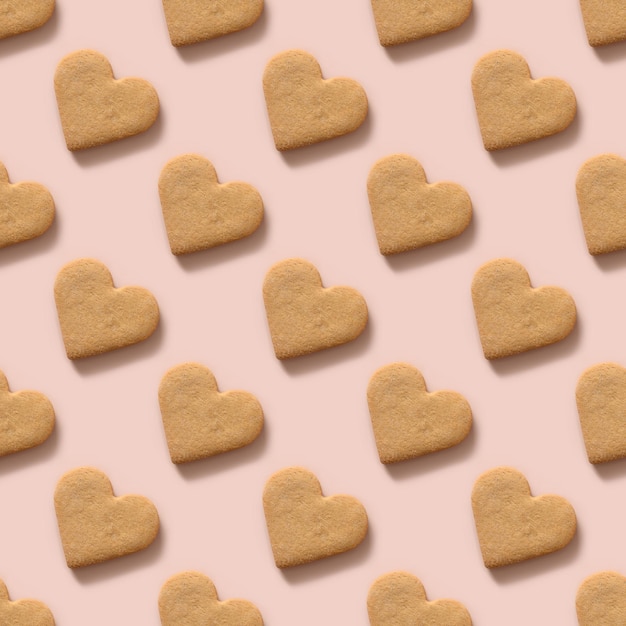 Valentine's day seamless pattern with homemade heart shaped cookies on pink background.