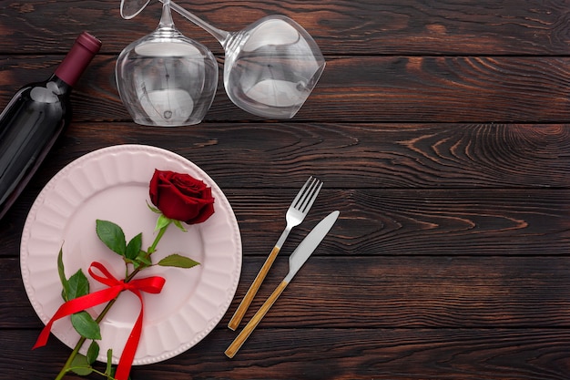 valentine's day table setting with plate, wine and glasses