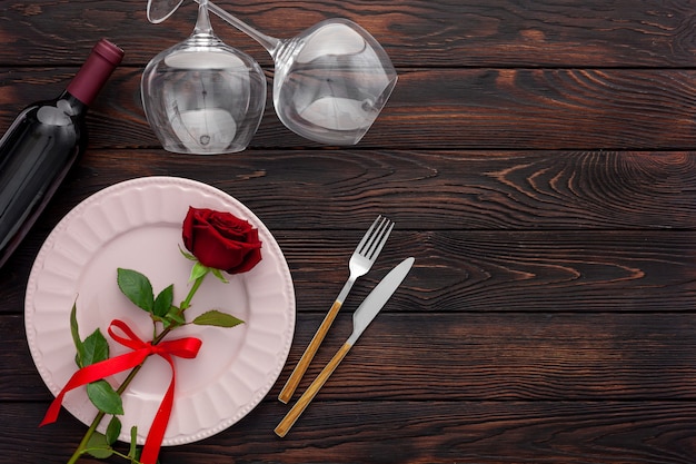 Valentine's day table setting with plate, wine and glasses