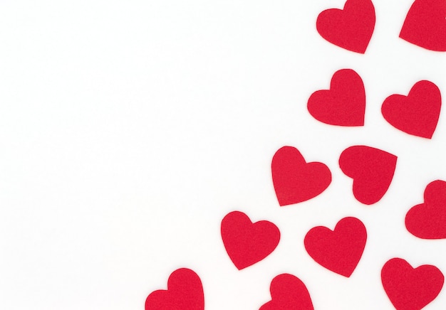 Valentine's Day white background with red hearts and copy space. Valentine greeting card.