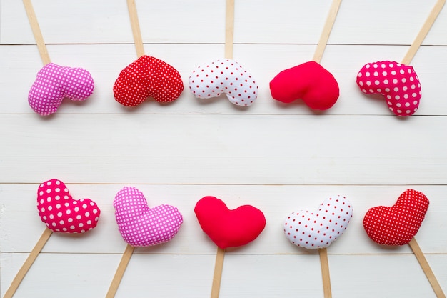 Valentine's hearts on white wooden background. 