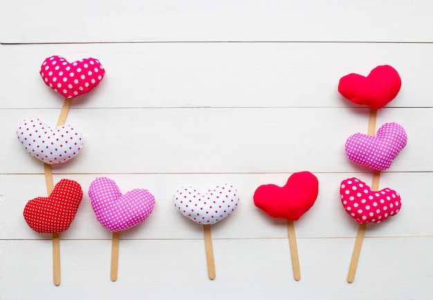 Valentine's hearts on white wooden background. 