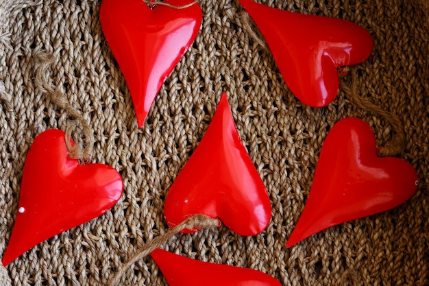 Valentine symbols, red hearts on basket surface.