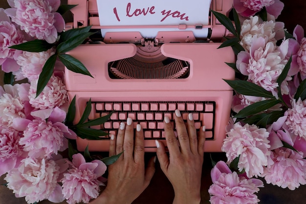 A valentine with pink peonies and a retro typewriter.