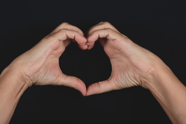 Valentineâs day background with hand making heart shape.