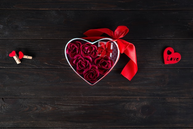 Valentines background with mini gift and rose in heart box 