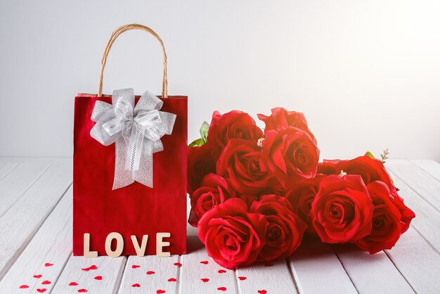 Valentines background with red rose, Heart shape, Gift bag, Wooden letters word 