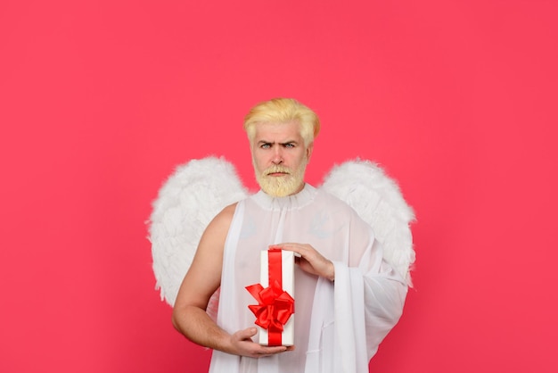 Valentines day angel cupid serious man in angel costume february cupid with gift love concept cupid