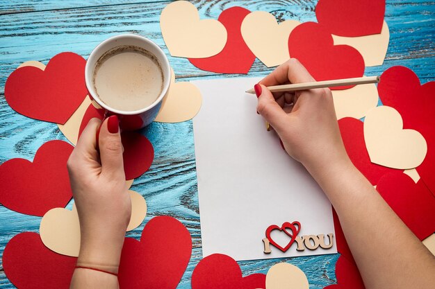 Valentines day background decorated with red hearts and love cardcopy space