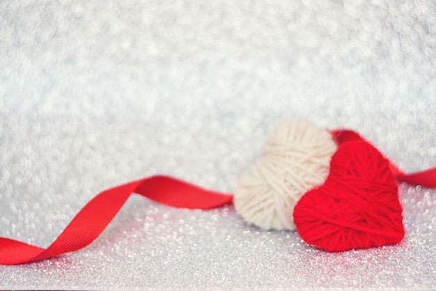 Valentines Day background, mockup with two red knitted fluffy heart