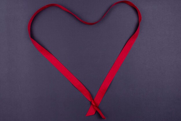 Valentines day background Red love ribbon on black background