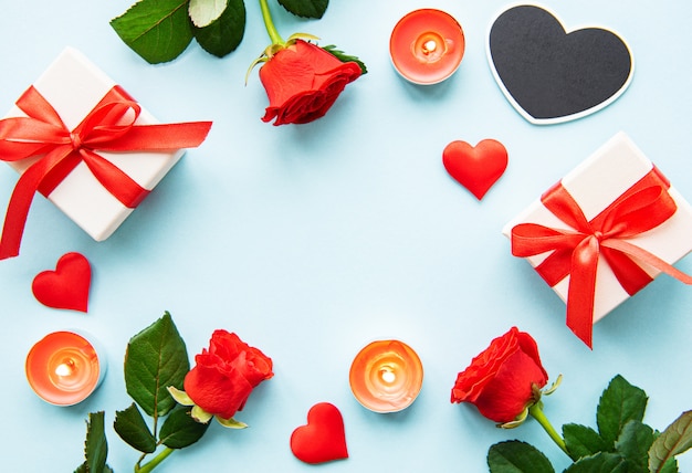 Valentines day background with gift boxes, red roses and hearts