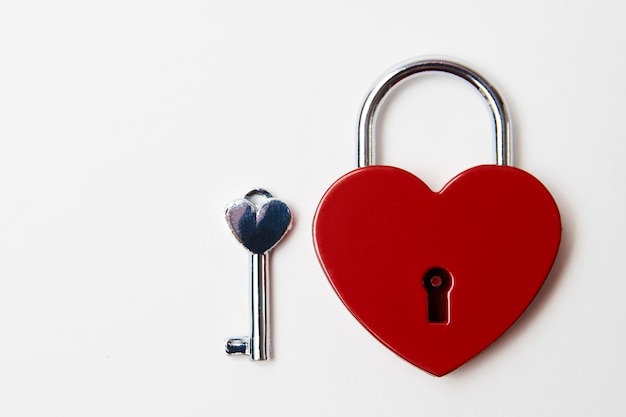 Valentines day background with red heart shaped lock and key. Love symbol heart padlock