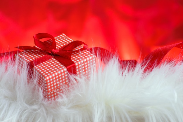 Valentines day background with a white fur and a red gift box