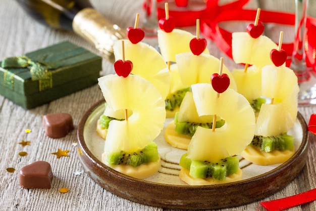 Valentines day or birthday romantic antipasto Canapes with cheese kiwi and pineapple