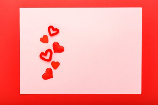 Valentines day card with copy space, frame. Pink background with red hearts.