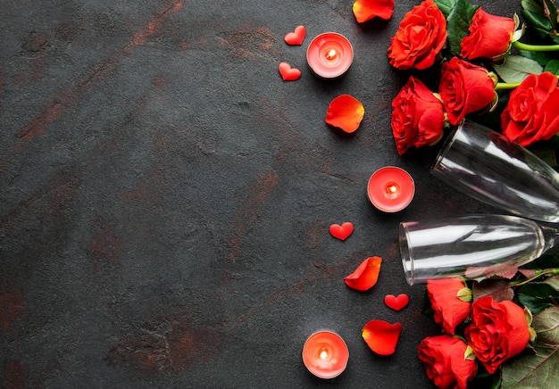 Valentines day composition with flowers, candles and champagne glasses