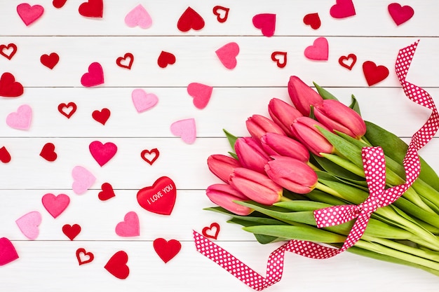 Valentines Day concept. Bouquet of pink tulips decorated with hearts. 