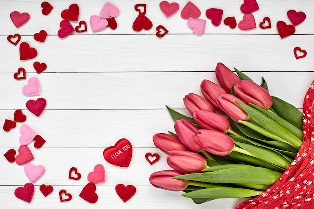 Valentines Day concept. Bouquet of pink tulips decorated with hearts. 