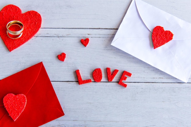 Valentines Day concept Hearts and love letter on wooden background