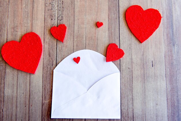 Valentines day concept love letter and hearts on wooden background