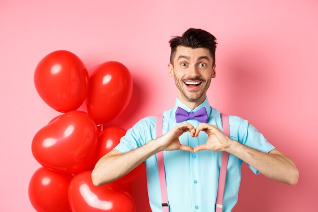 Valentines day concept. Romantic guy looking happy and smiling