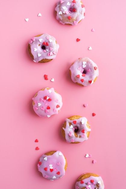 Valentines day concept. Small donuts isolated on pink background