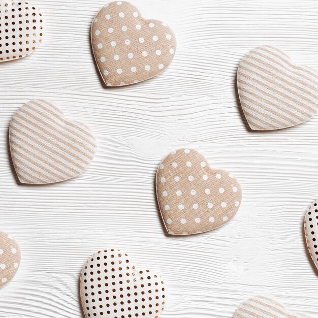 Photo valentines day concept soft toy hearts from linen cloth with golden color striped or dots on