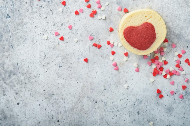 Valentines day cookies Shortbread cookies inside a sweet red heart on pink plate on grey background Mothers day Womans day Sweet holidays baking Top view