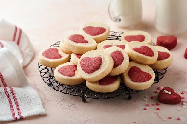 Valentines day cookies Shortbread cookies inside a sweet red heart on pink plate on pink background Mothers day Womans day Sweet holidays baking Top view