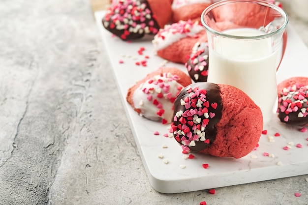 Valentines day cookies Shortbread cookies with glaze white and dark chocolate and heart sprinkles on plate on white background Mothers day Womans day Sweet holidays baking Top view