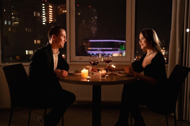 valentines day dinner by candlelight couple in love on a date night meeting man and woman with wine romantic date at home